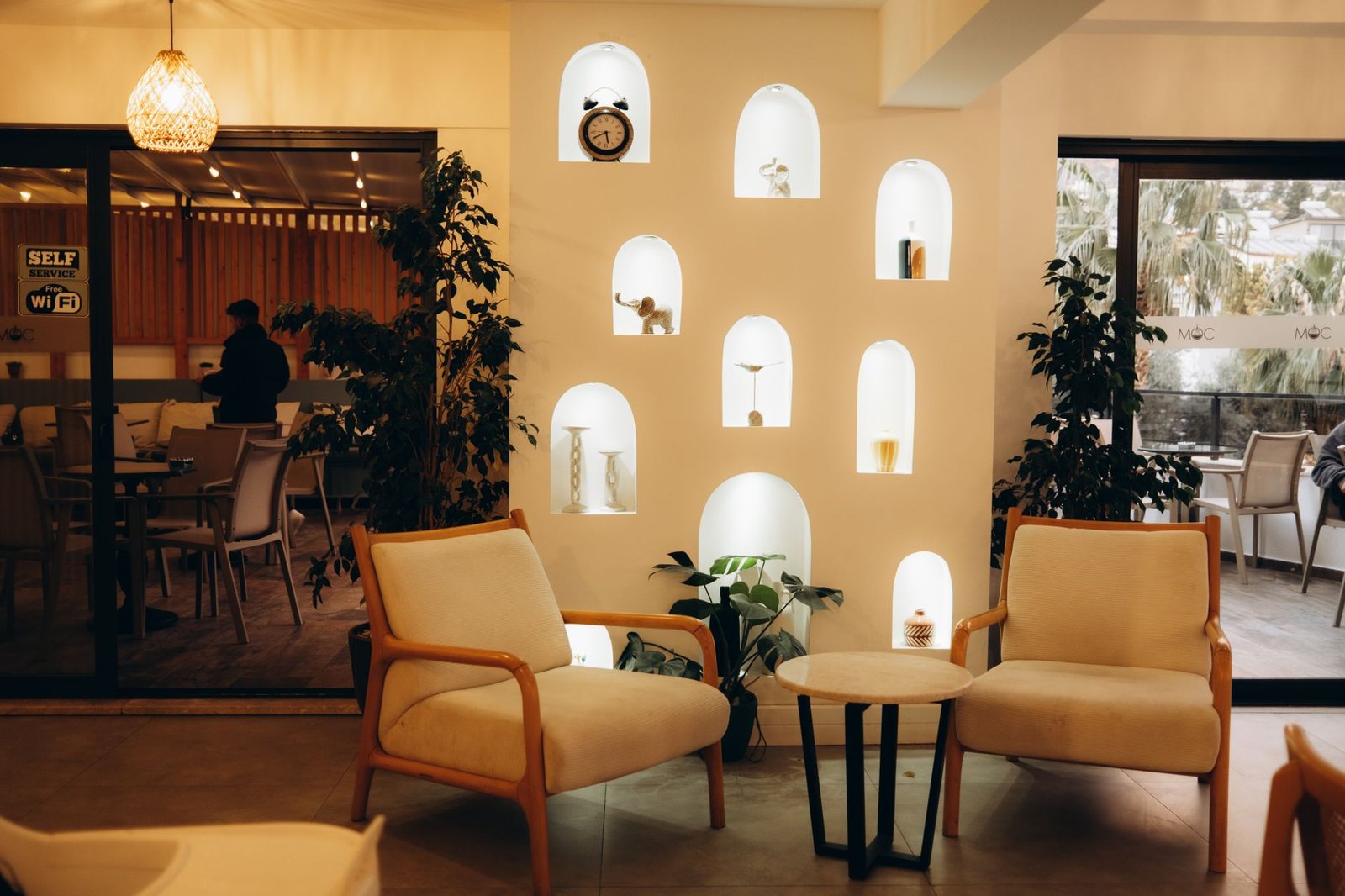 Stylish modern cafe interior Dubai 2026 — barista counter and warm seating zones