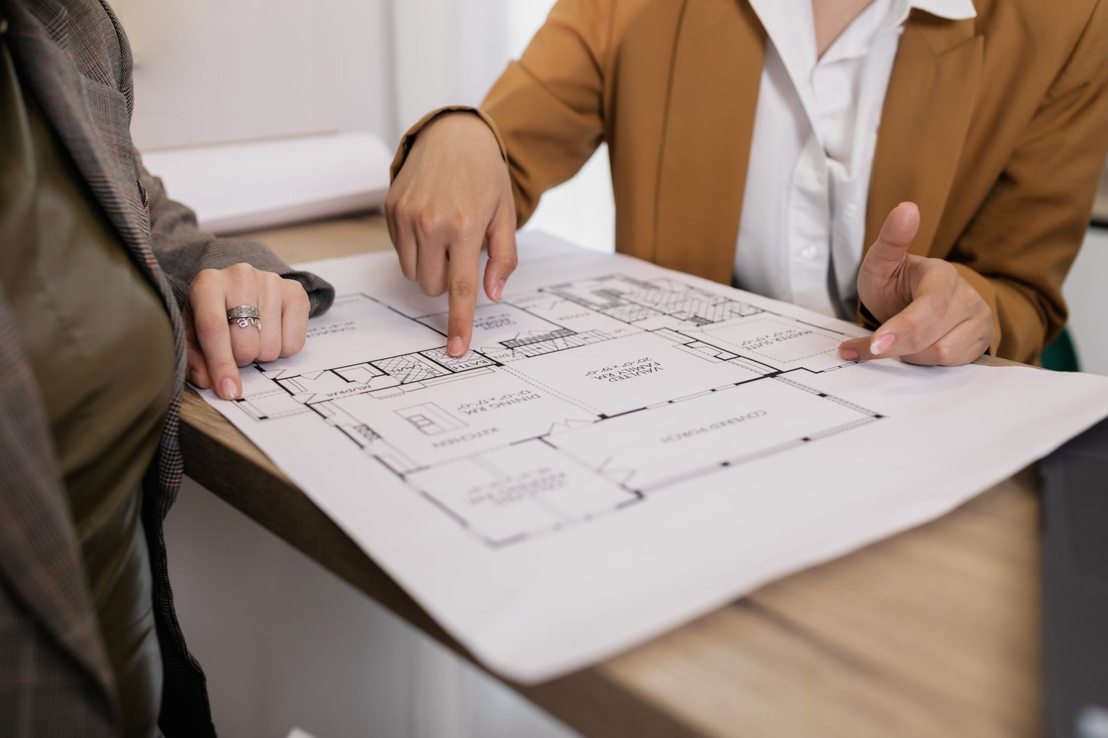 Architectural fit-out drawings, MEP layouts and a Dubai authority permit application laid out on a project management desk in Dubai