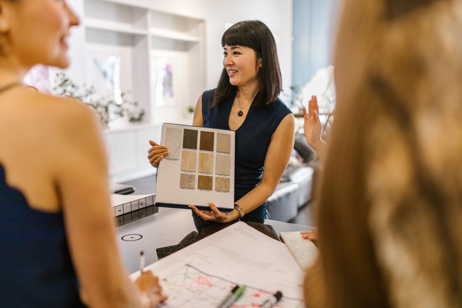 Interior designer reviewing architectural plans and material samples at a Dubai project briefing