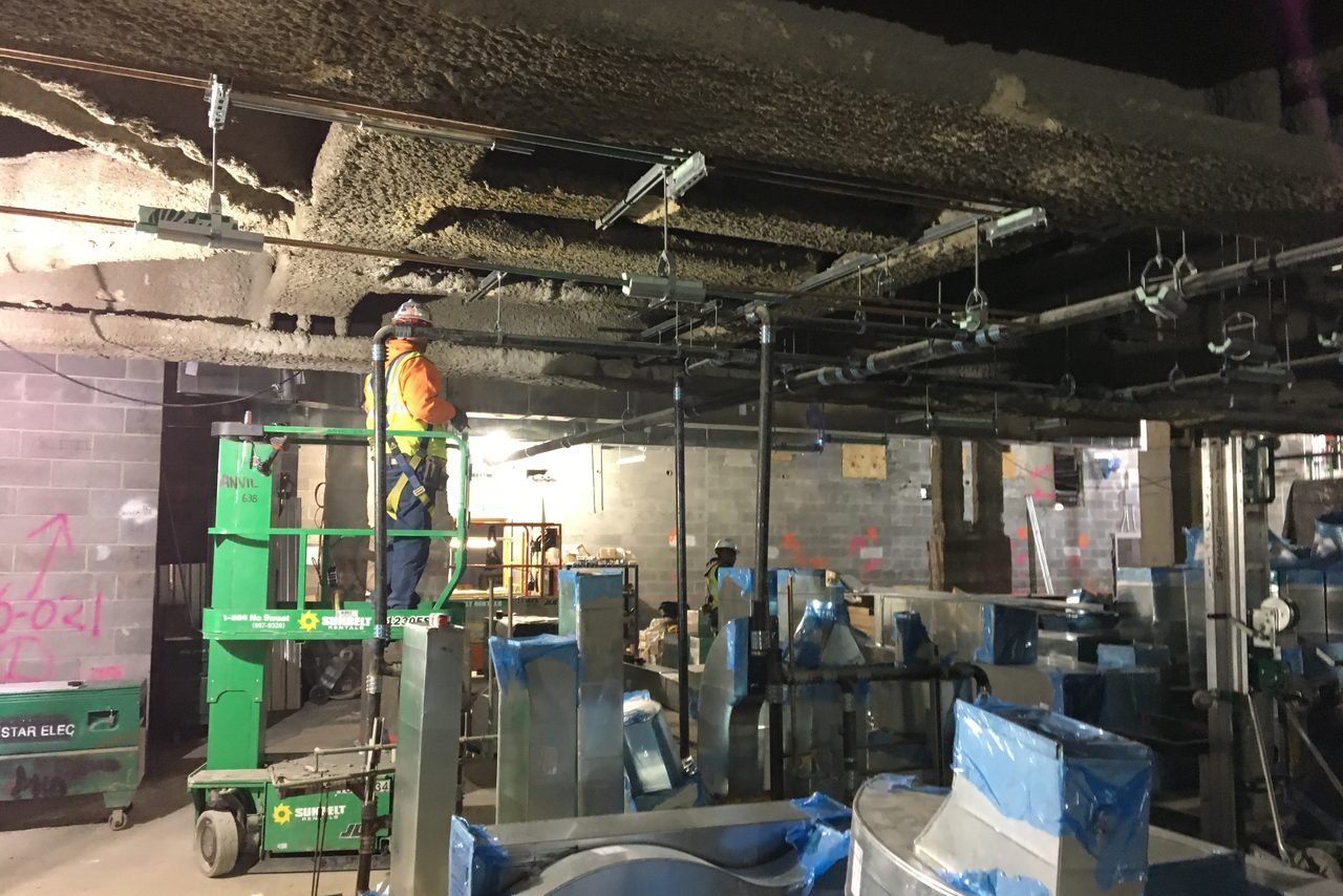 HVAC air balancing Dubai - rectangular supply ductwork being installed above an open ceiling before the grid closes, the stage at which airflow can still be measured and adjusted