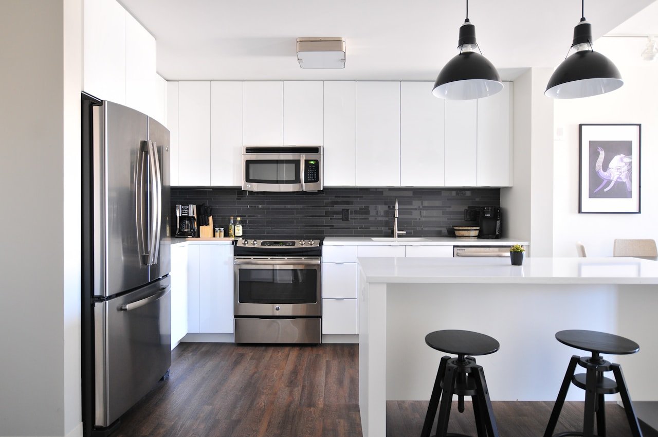 Modern kitchen renovation Dubai — clean cabinetry and stone countertops