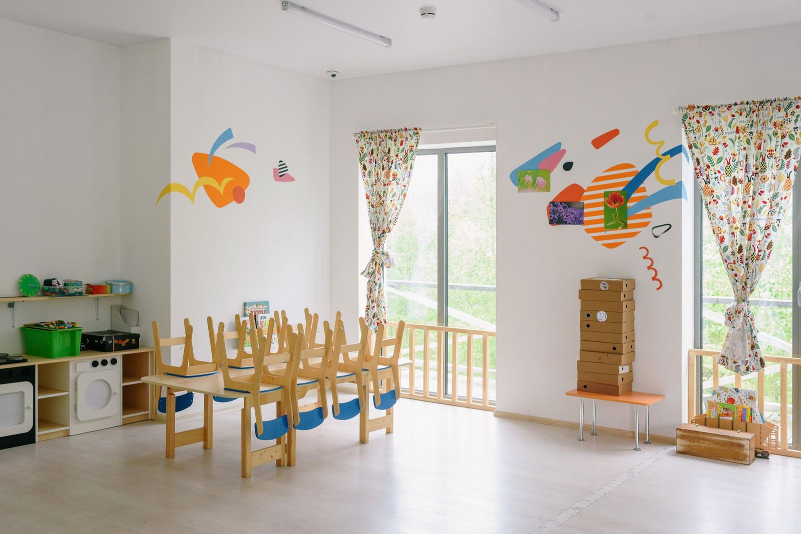 Bright nursery classroom interior with colourful play zones and child-height furniture — UAE 2026