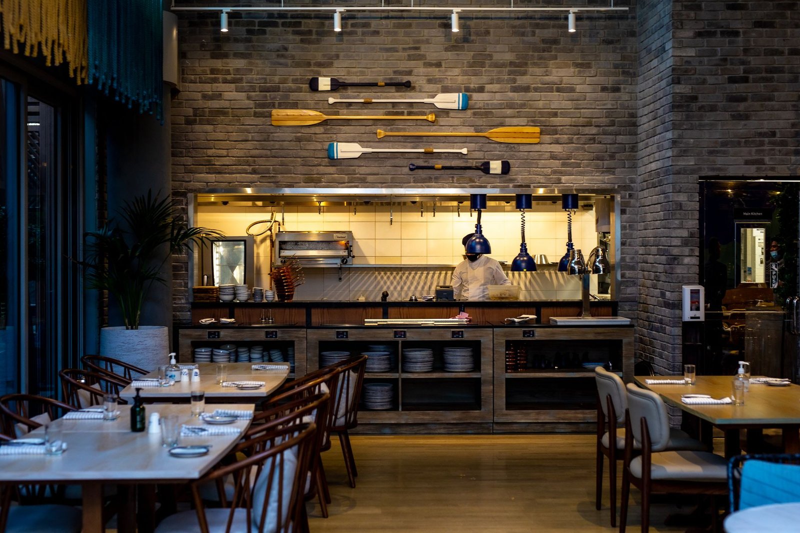 Modern restaurant interior design in Dubai — custom joinery, statement lighting, dining area