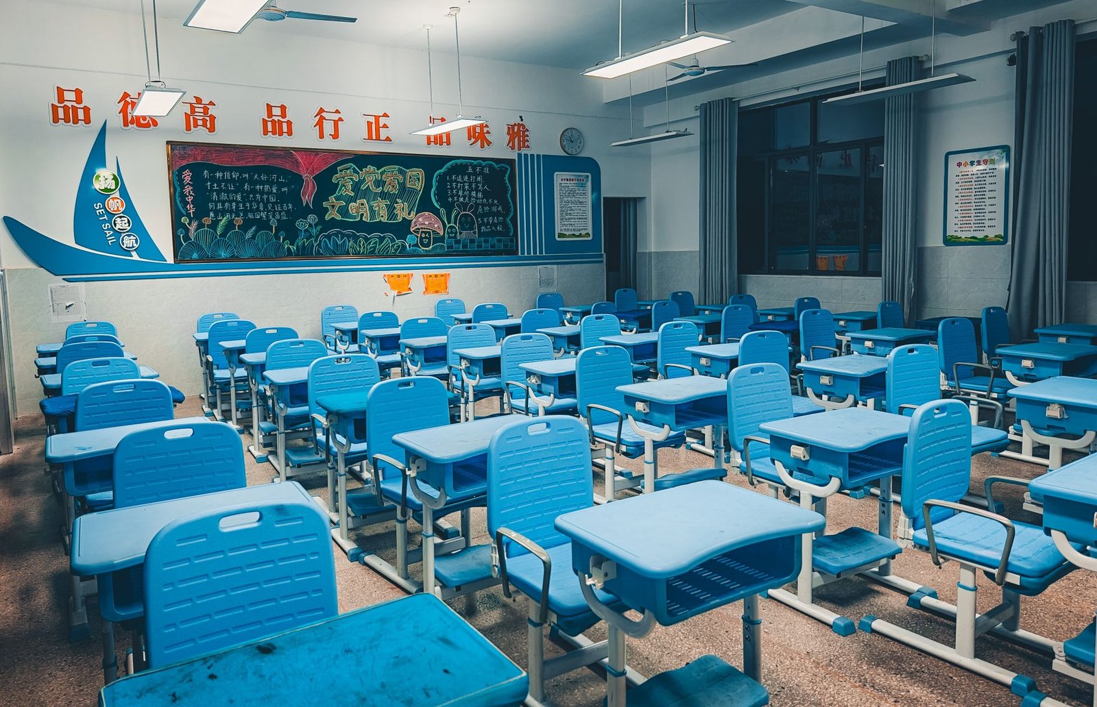 Modern school classroom interior with natural light, blue desks and vibrant learning environment in UAE