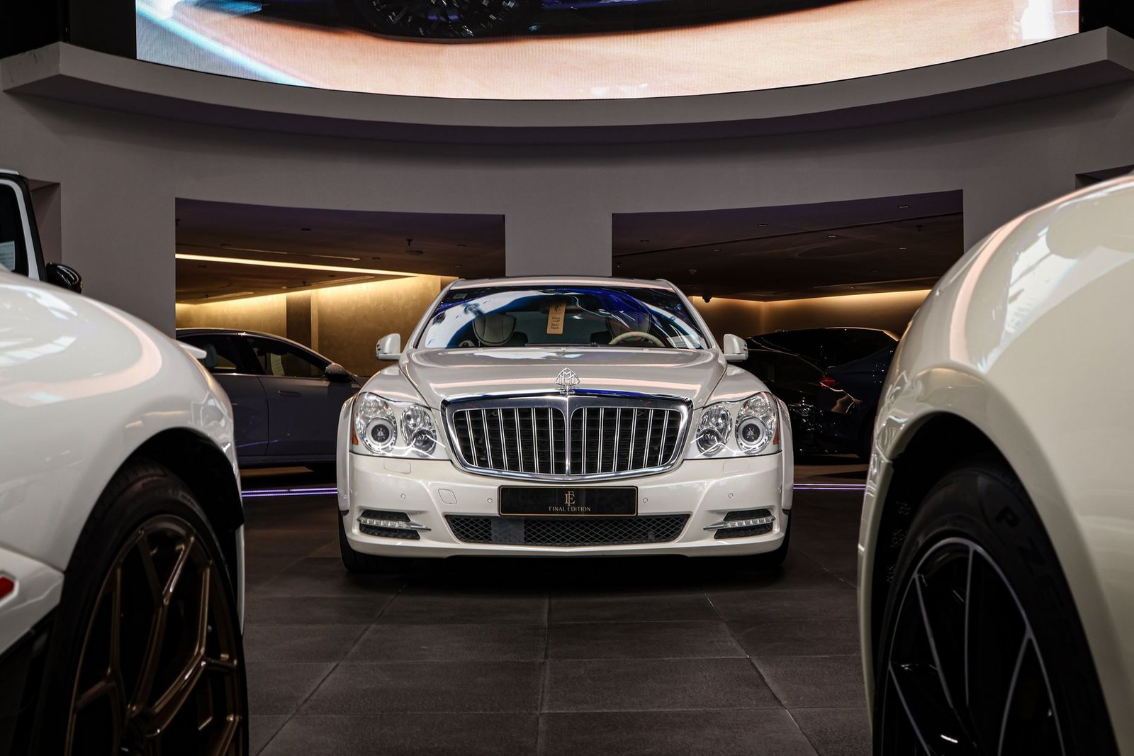 Luxury showroom interior in Dubai with product display lighting, marble flooring and branded focal wall